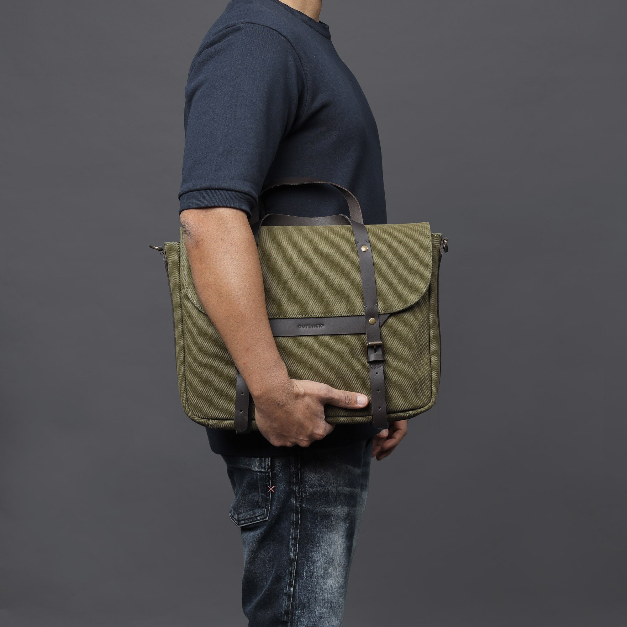 Oslo Canvas Briefcase made from durable cotton canvas, featuring leather straps and multiple pockets for organization, suitable for laptops up to 13 inches.