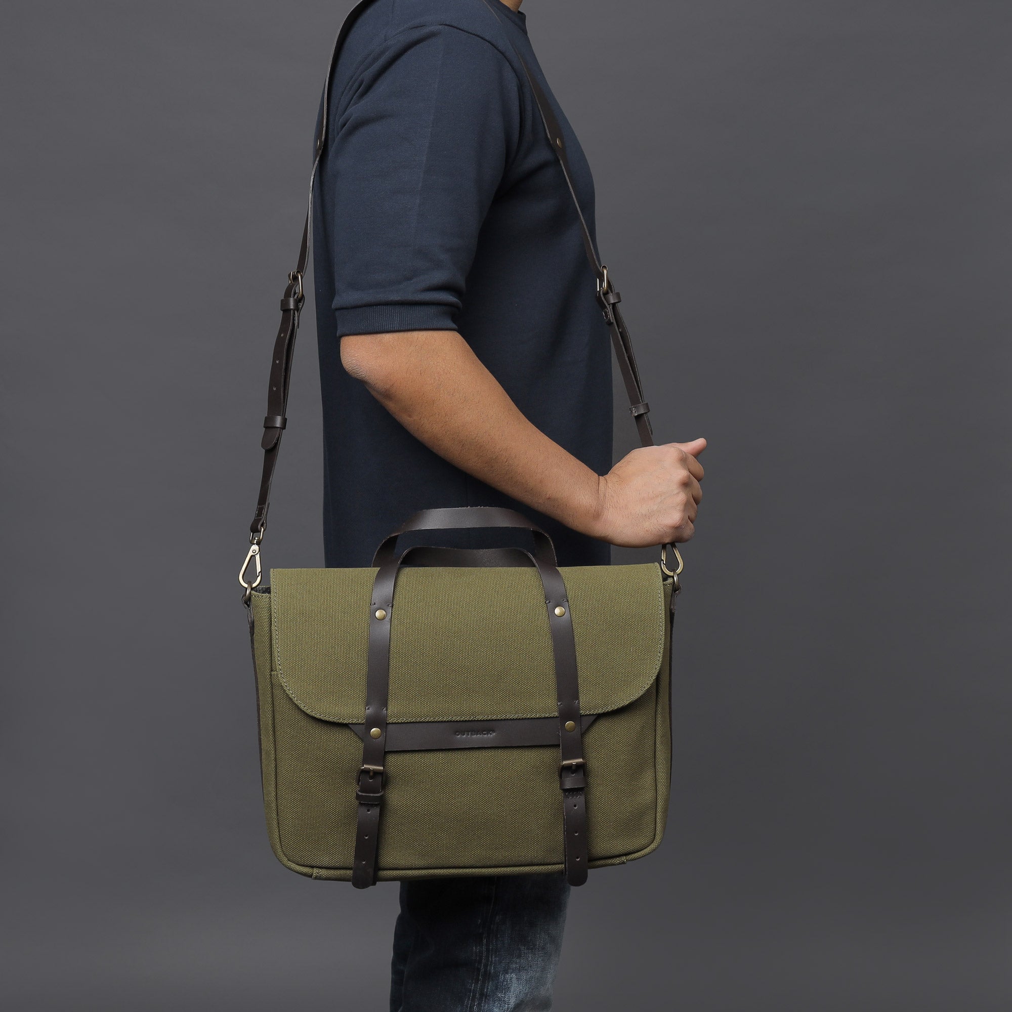 Oslo Canvas Briefcase made from durable cotton canvas, featuring leather straps and multiple pockets for organization, suitable for laptops up to 13 inches.