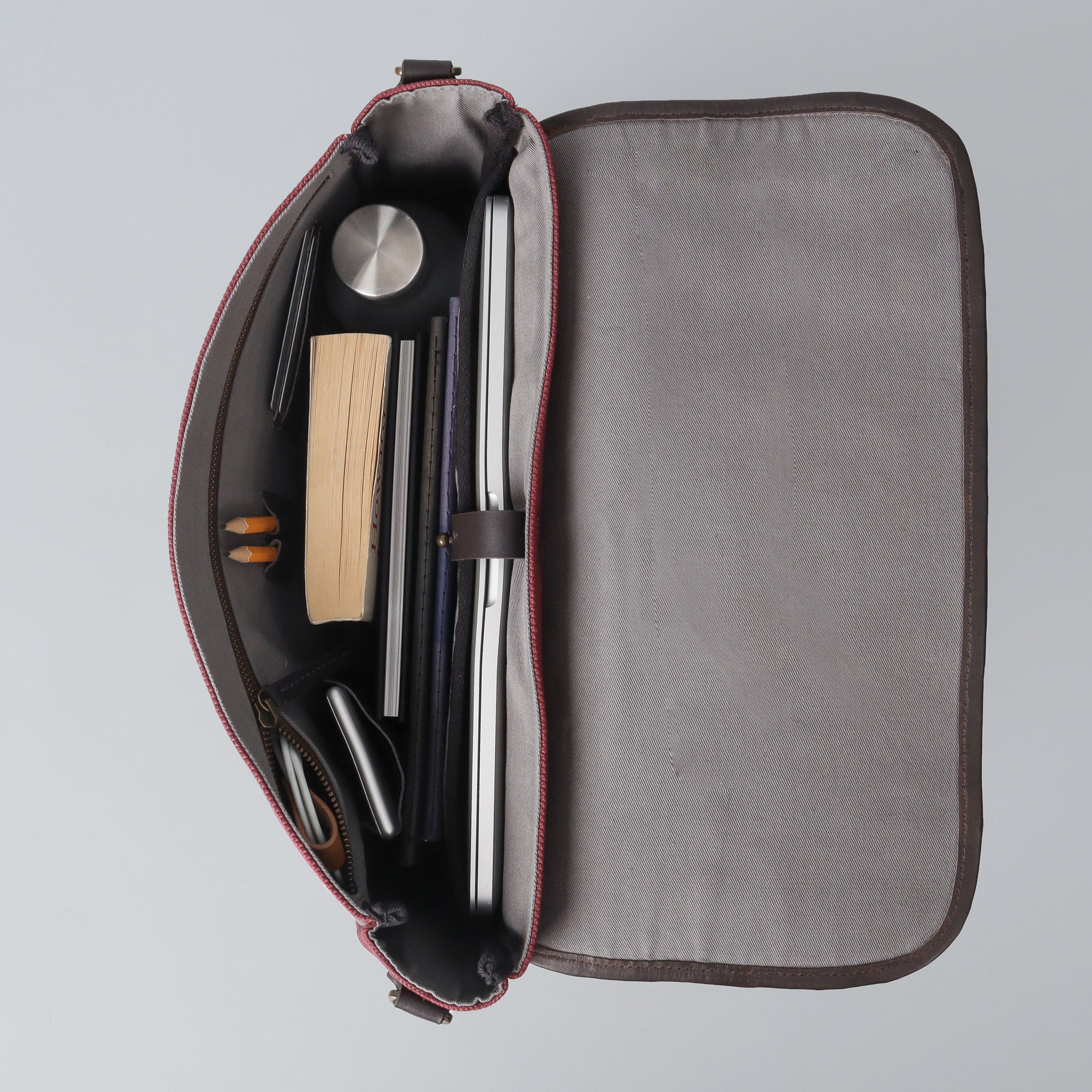 Oslo Canvas Messenger Bag featuring a durable design with leather strap and multiple compartments for laptop and essentials.