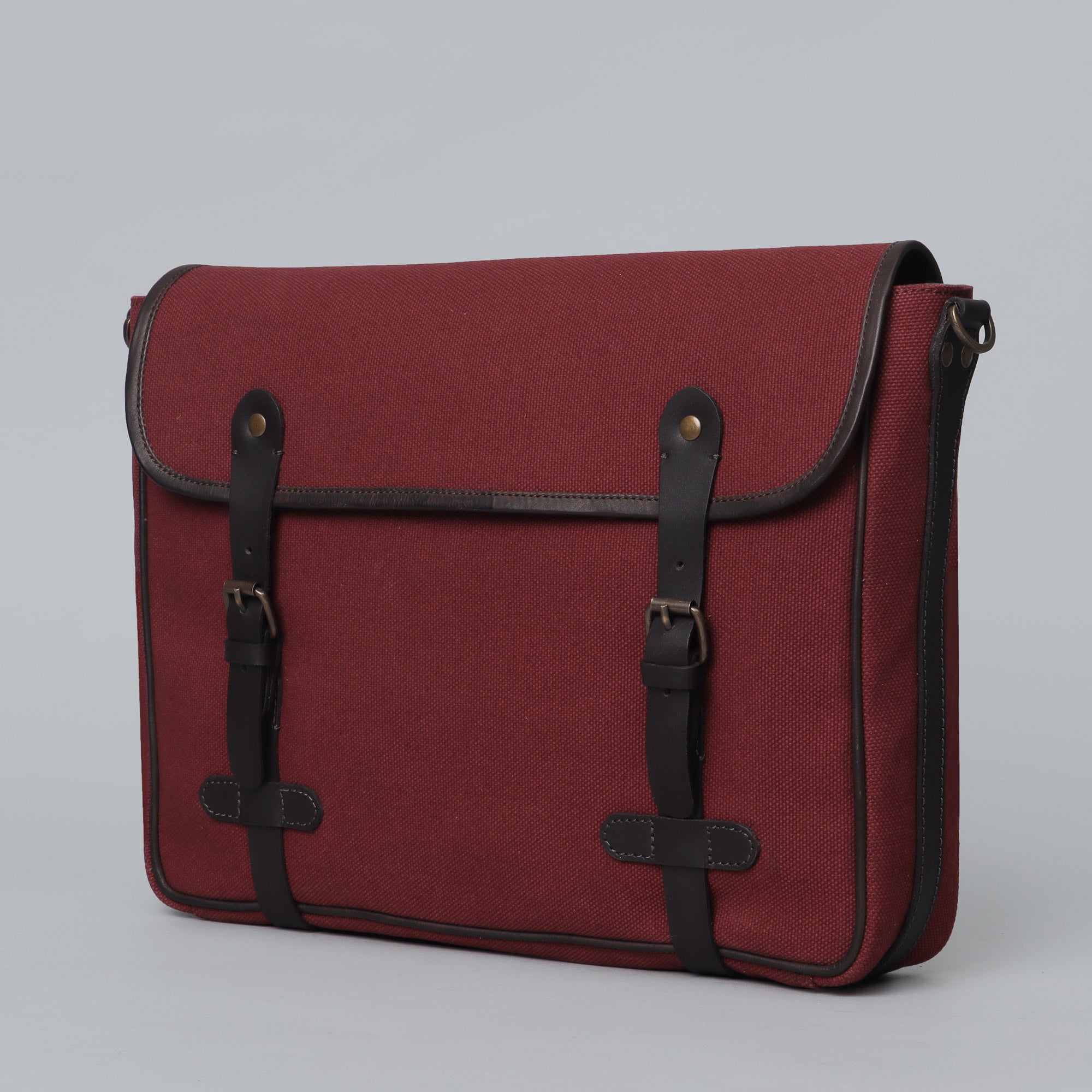 Oslo Canvas Messenger Bag featuring a durable design with leather strap and multiple compartments for laptop and essentials.