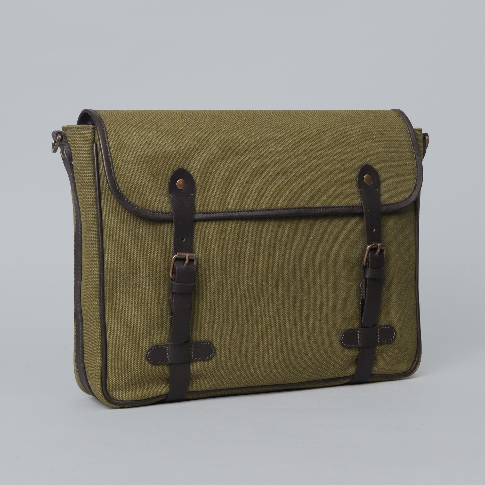 Oslo Canvas Messenger Bag featuring a durable design, leather strap, and multiple compartments for organization.