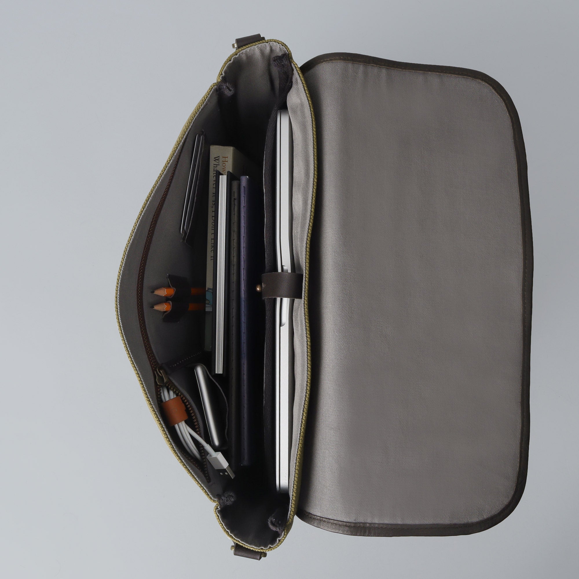 Oslo Canvas Messenger Bag featuring a durable design, leather strap, and multiple compartments for organization.