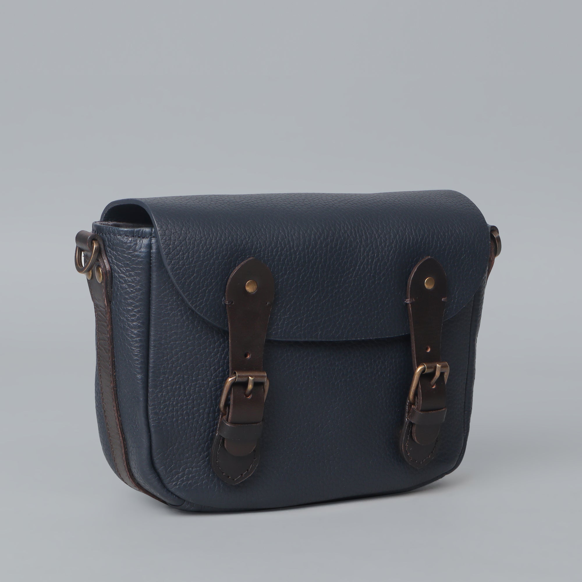 Oslo Crossbody Bag made from premium leather with multiple compartments and antique brass hardware, showcasing its handcrafted quality.