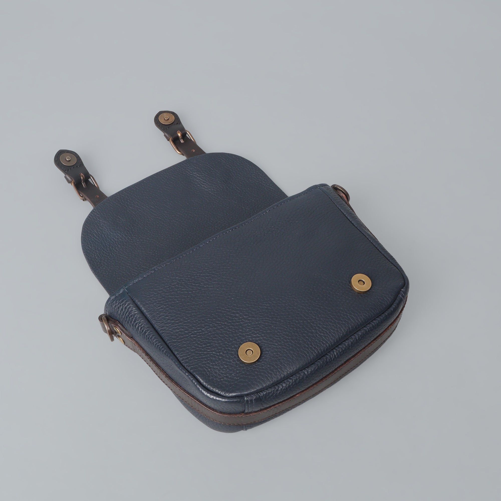 Oslo Crossbody Bag made from premium leather with multiple compartments and antique brass hardware, showcasing its handcrafted quality.