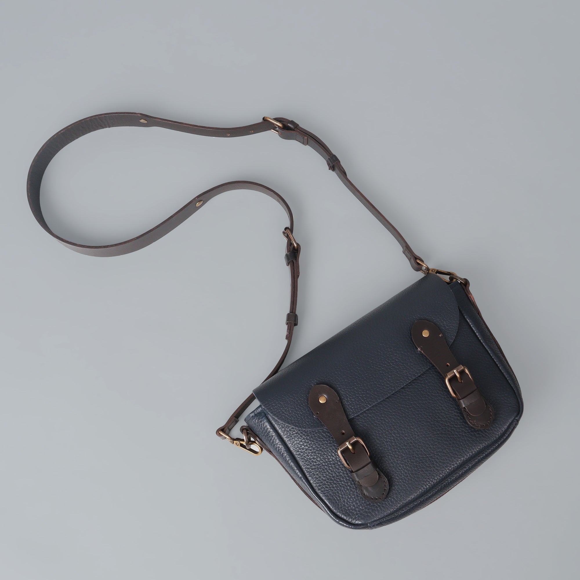 Oslo Crossbody Bag made from premium leather with multiple compartments and antique brass hardware, showcasing its handcrafted quality.