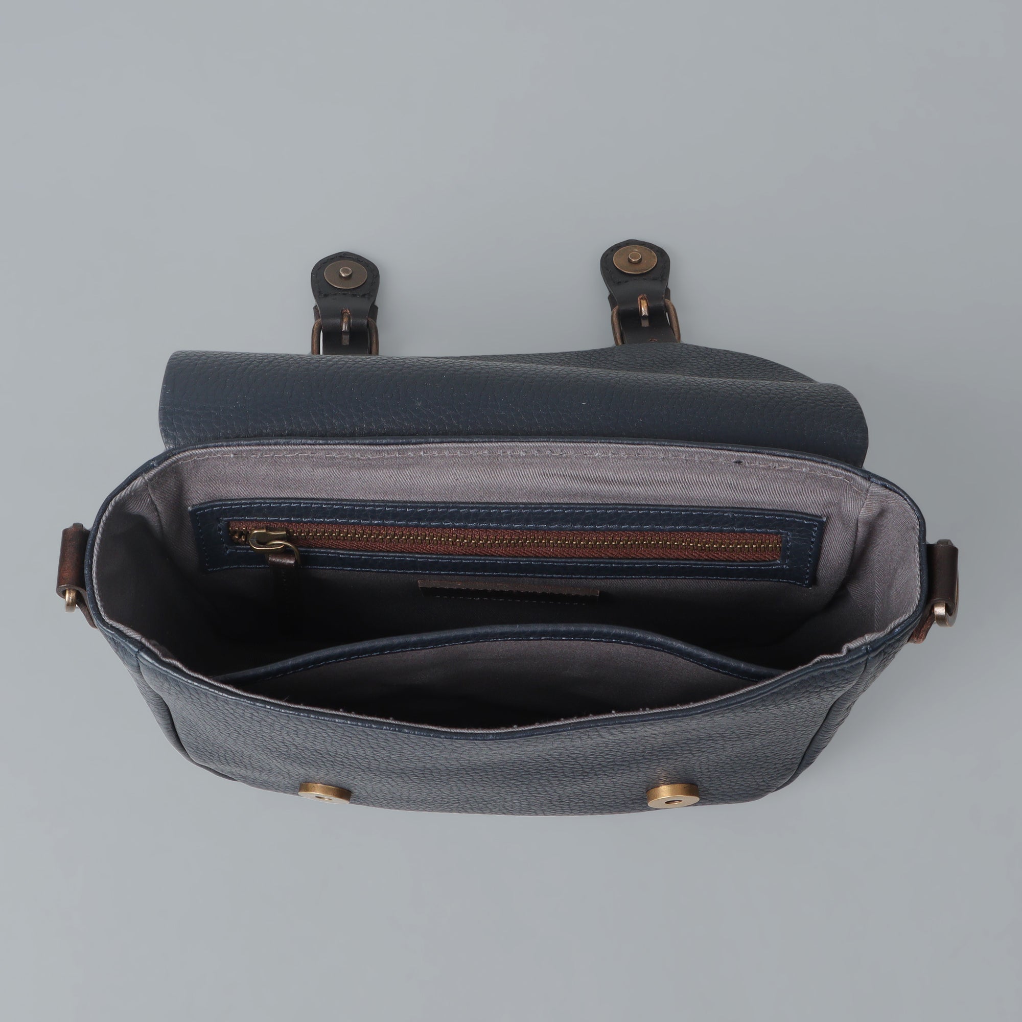 Oslo Crossbody Bag made from premium leather with multiple compartments and antique brass hardware, showcasing its handcrafted quality.