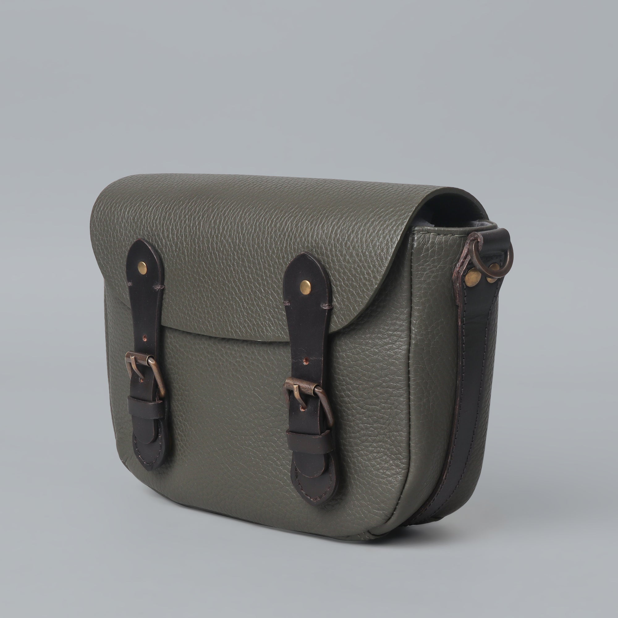 Oslo Crossbody Bag made from premium leather with multiple compartments and antique brass hardware, showcasing its elegant design.