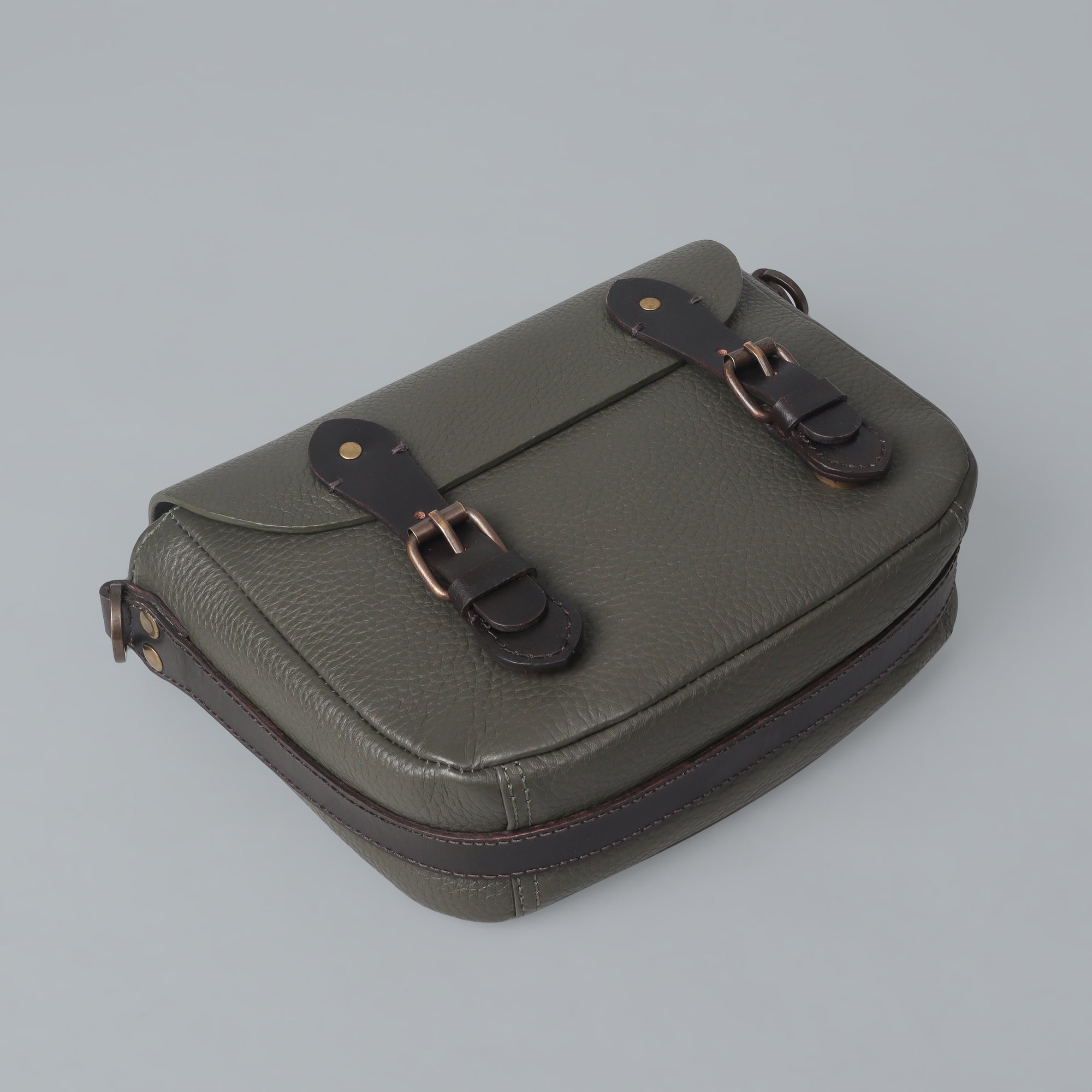 Oslo Crossbody Bag made from premium leather with multiple compartments and antique brass hardware, showcasing its elegant design.