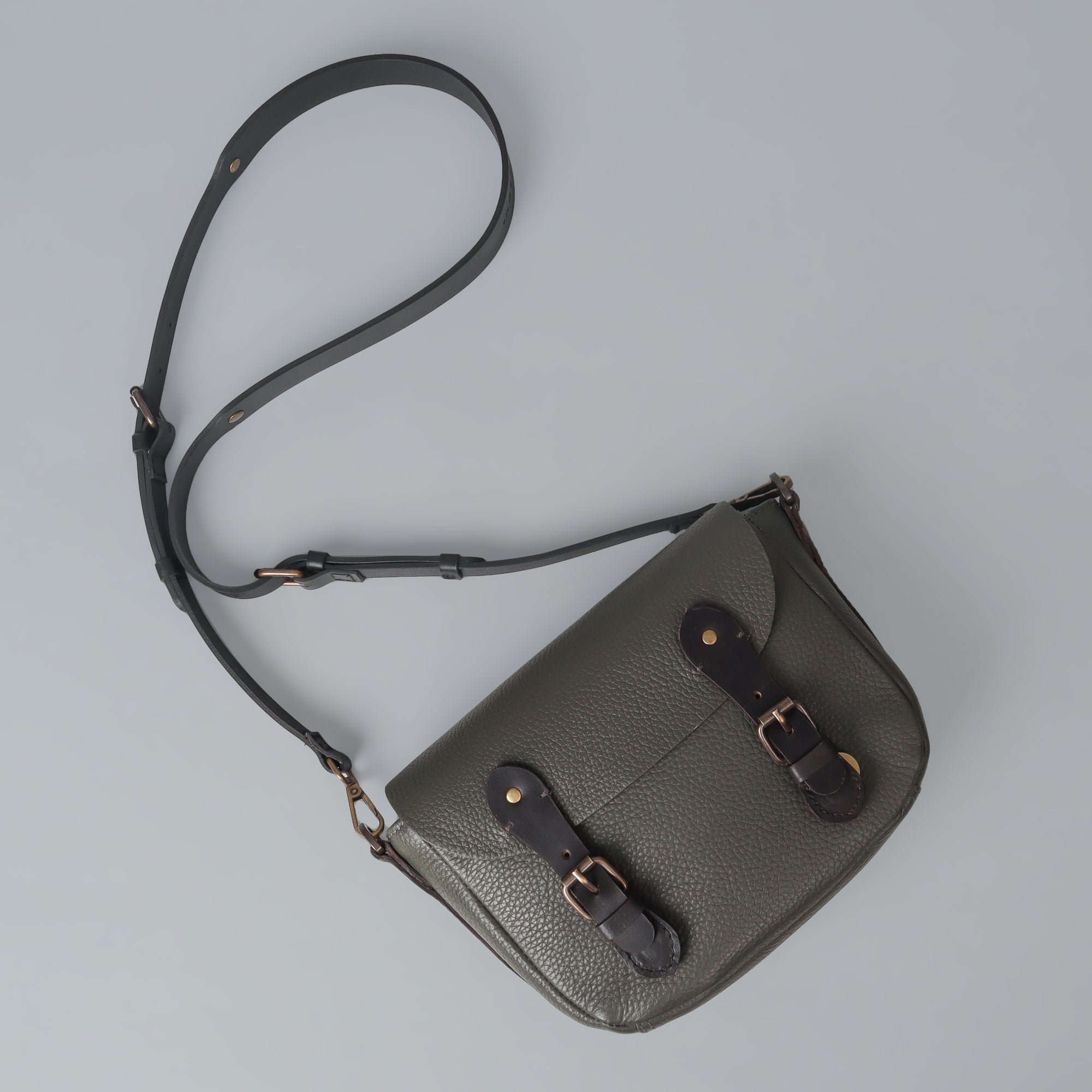 Oslo Crossbody Bag made from premium leather with multiple compartments and antique brass hardware, showcasing its elegant design.