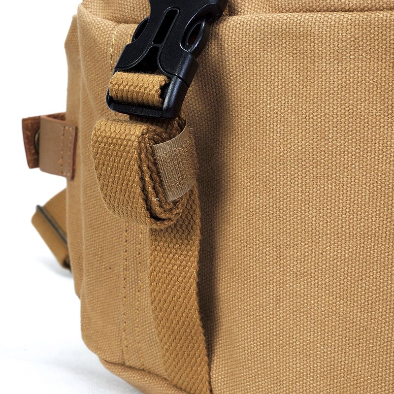 Outdoor Canvas Leisure One-shoulder Camera Bag with tripod straps and large capacity for lenses, designed for photographers.