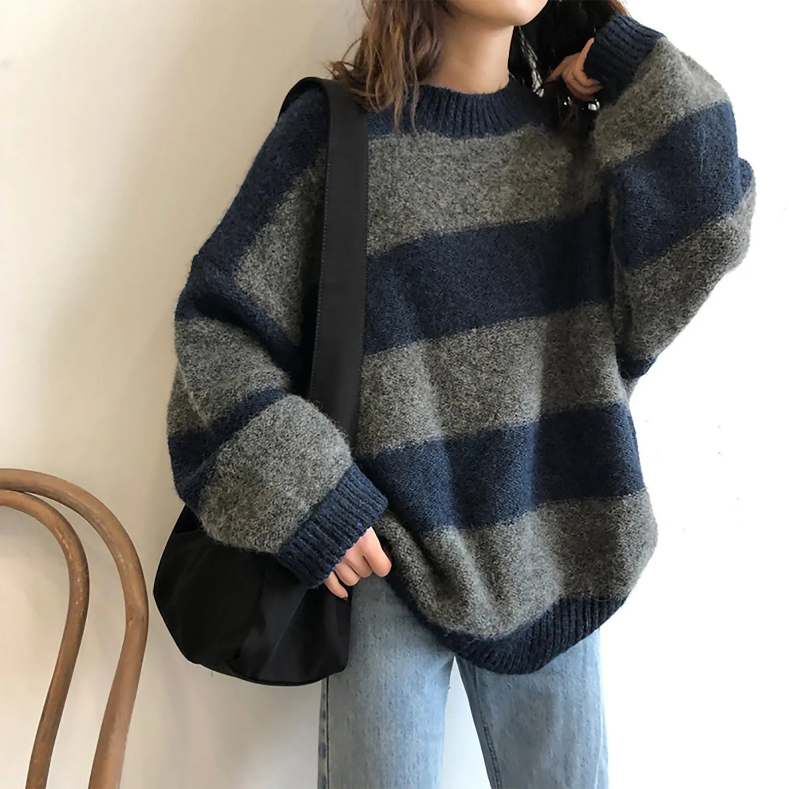 A cozy oversized striped sweater featuring a classic striped pattern, O-neck collar, and full sleeves, perfect for autumn and winter wear.