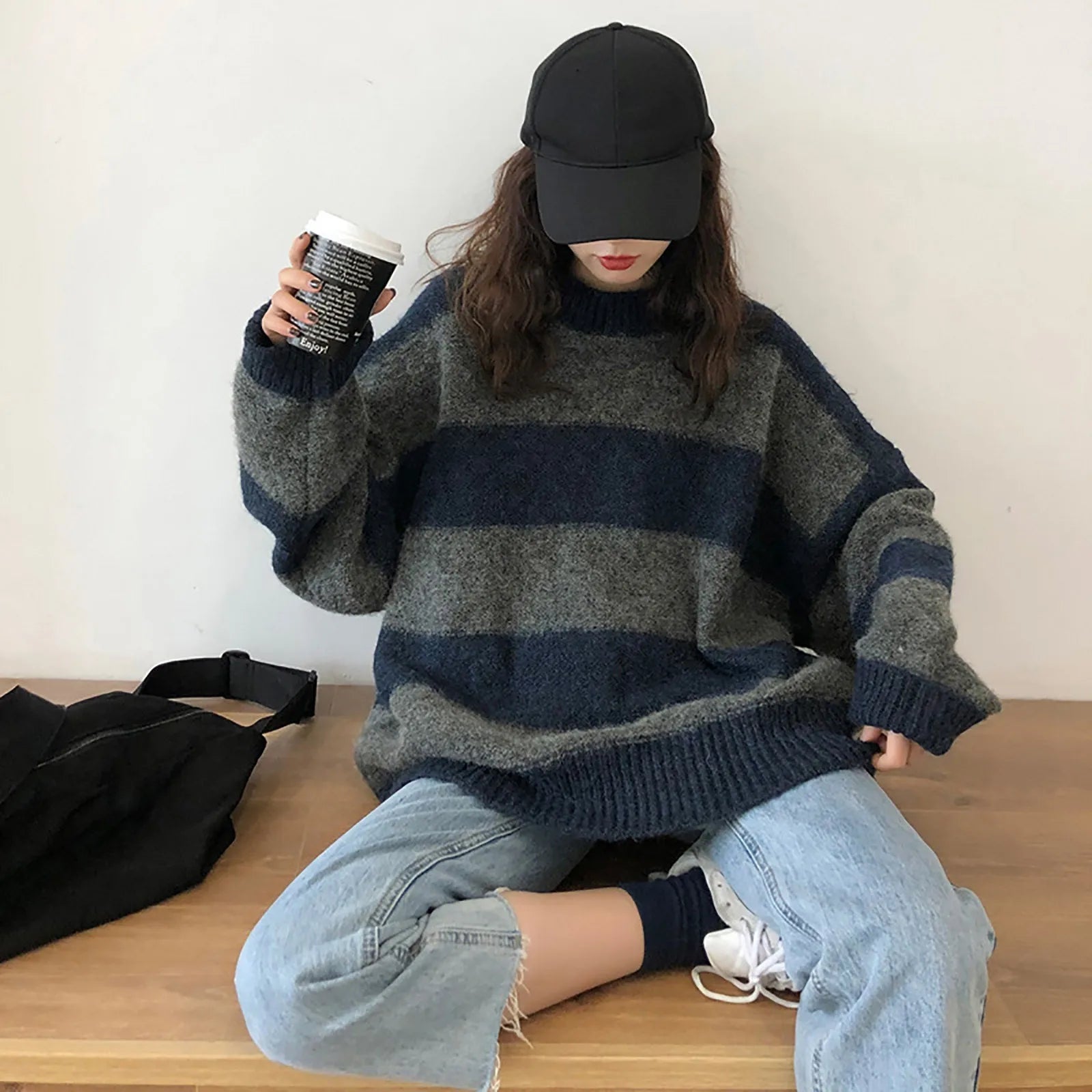 A cozy oversized striped sweater featuring a classic striped pattern, O-neck collar, and full sleeves, perfect for autumn and winter wear.