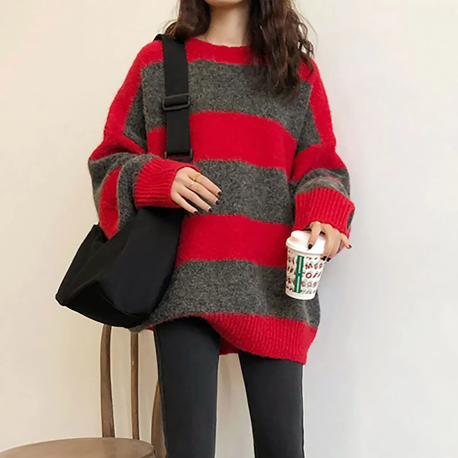 A cozy oversized striped sweater featuring a classic striped pattern, O-neck collar, and full sleeves, perfect for autumn and winter wear.