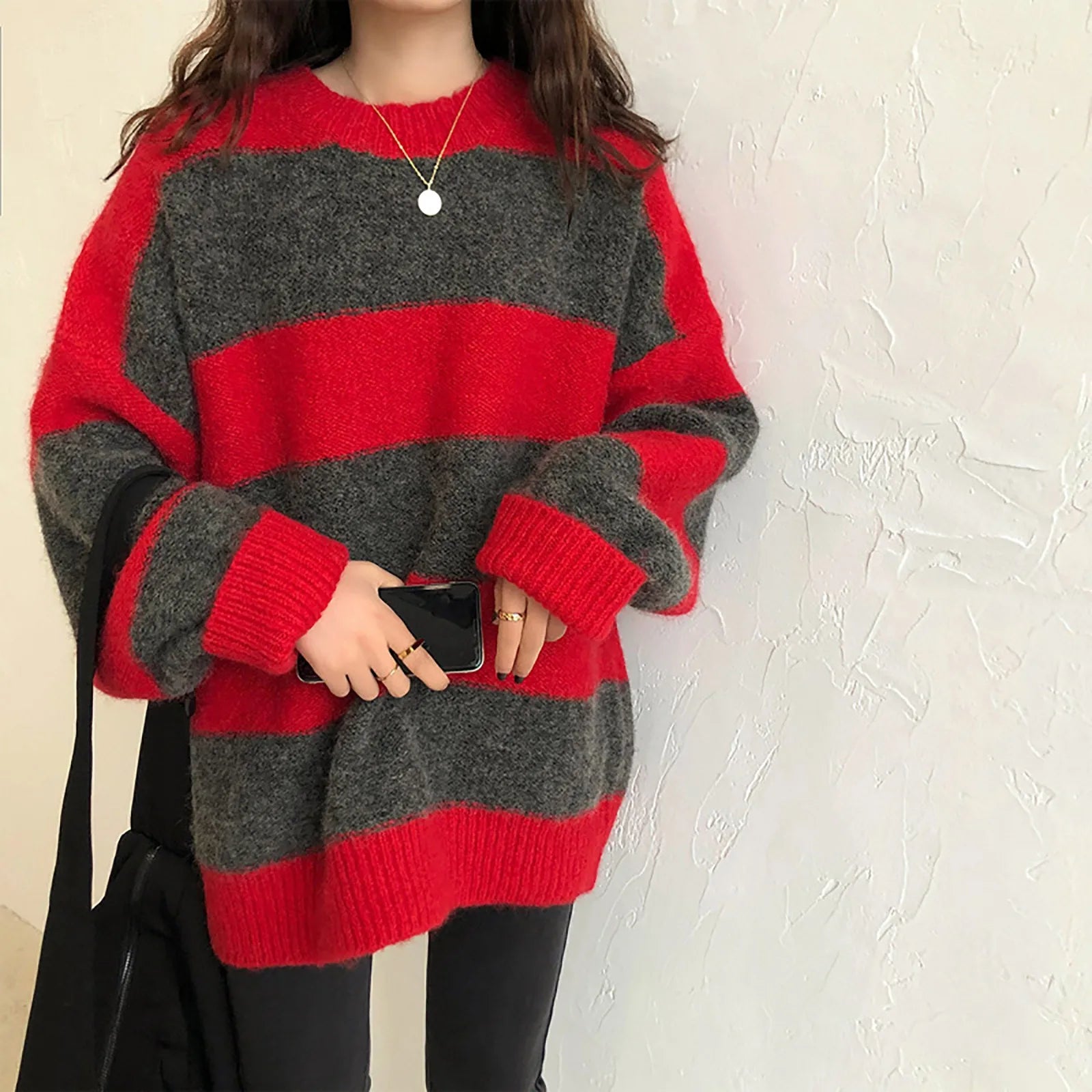 A cozy oversized striped sweater featuring a classic striped pattern, O-neck collar, and full sleeves, perfect for autumn and winter wear.