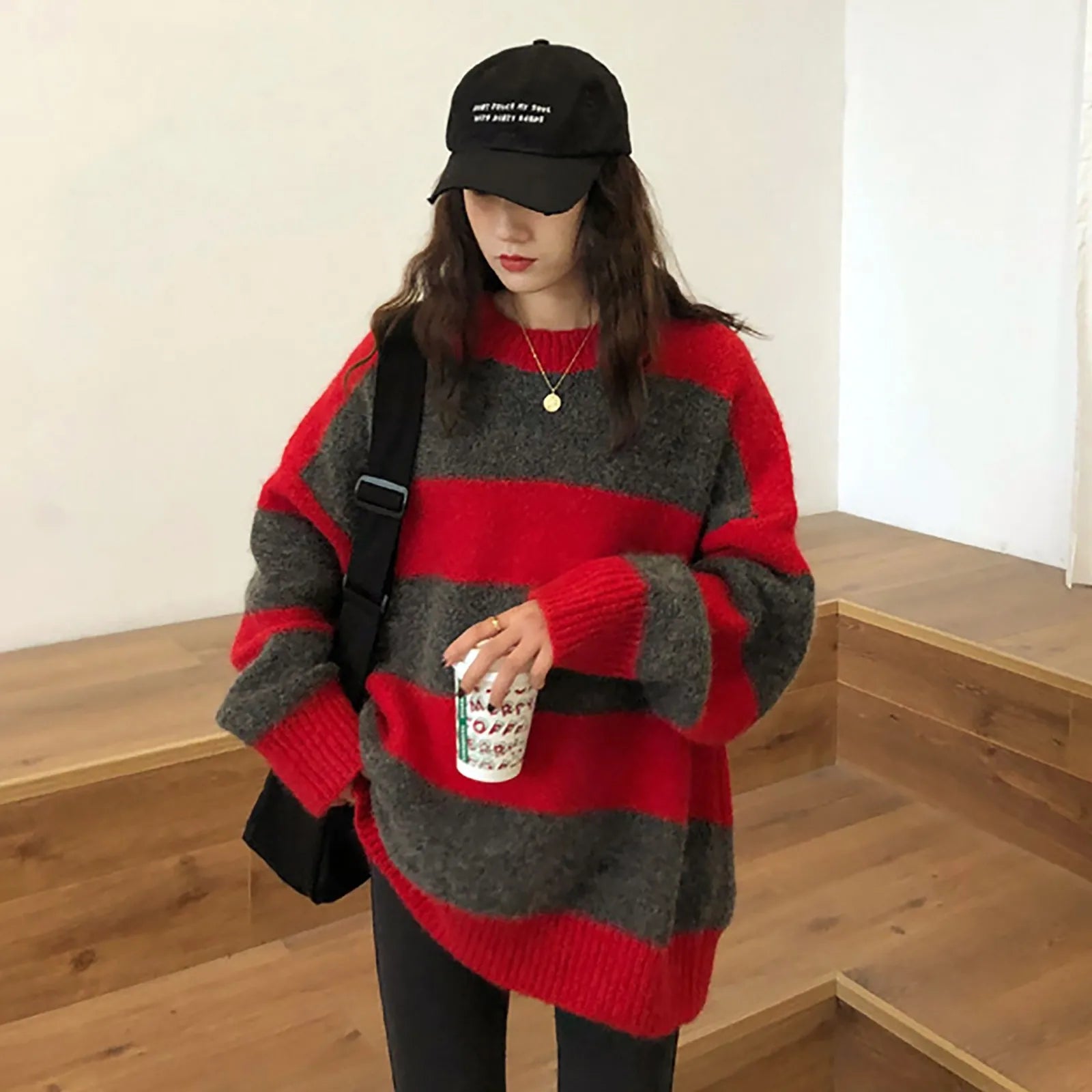 A cozy oversized striped sweater featuring a classic striped pattern, O-neck collar, and full sleeves, perfect for autumn and winter wear.