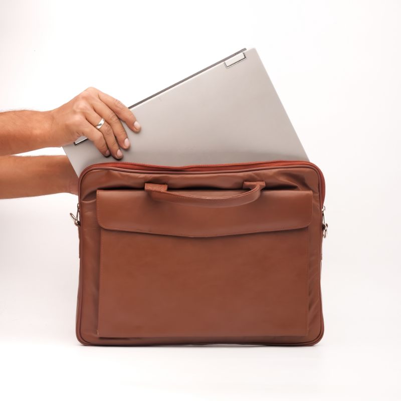 Parker Slim Leather Laptop Bag in Tan, showcasing its sleek design, adjustable shoulder strap, and multiple compartments for organization.