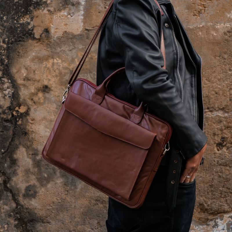 Parker Slim Leather Laptop Bag in Tan, showcasing its sleek design, adjustable shoulder strap, and multiple compartments for organization.