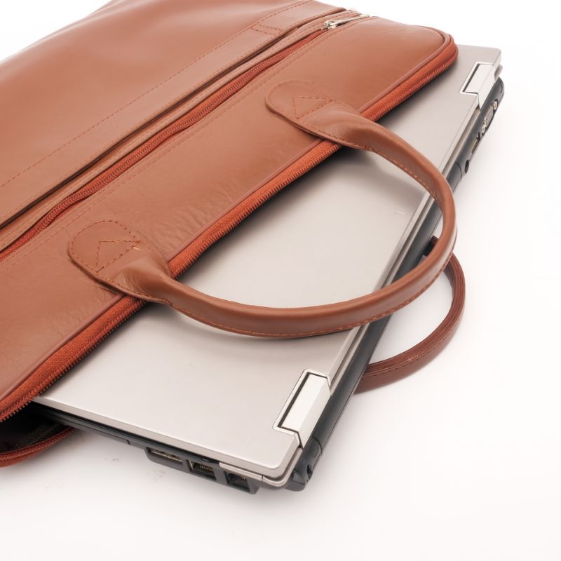 Parker Slim Leather Laptop Bag in Tan, showcasing its sleek design, adjustable shoulder strap, and multiple compartments for organization.