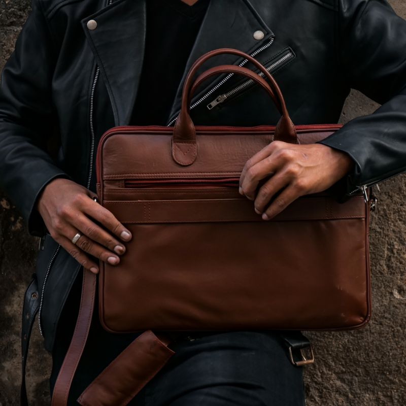 Parker Slim Leather Laptop Bag in Tan, showcasing its sleek design, adjustable shoulder strap, and multiple compartments for organization.