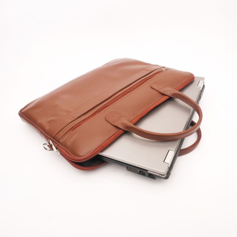 Parker Slim Leather Laptop Bag in Tan, showcasing its sleek design, adjustable shoulder strap, and multiple compartments for organization.