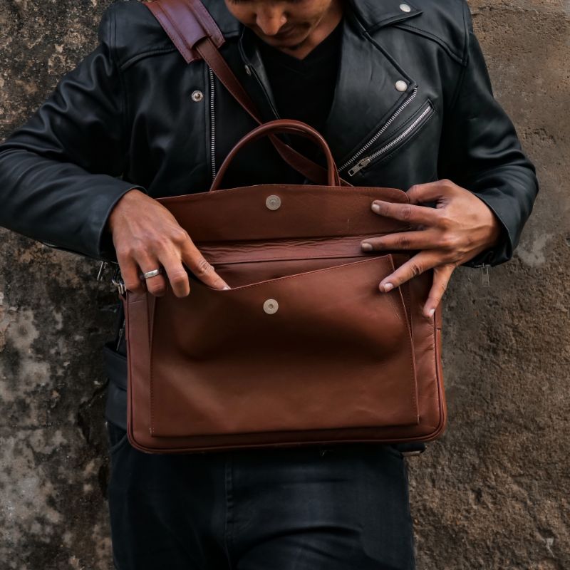 Parker Slim Leather Laptop Bag in Tan, showcasing its sleek design, adjustable shoulder strap, and multiple compartments for organization.