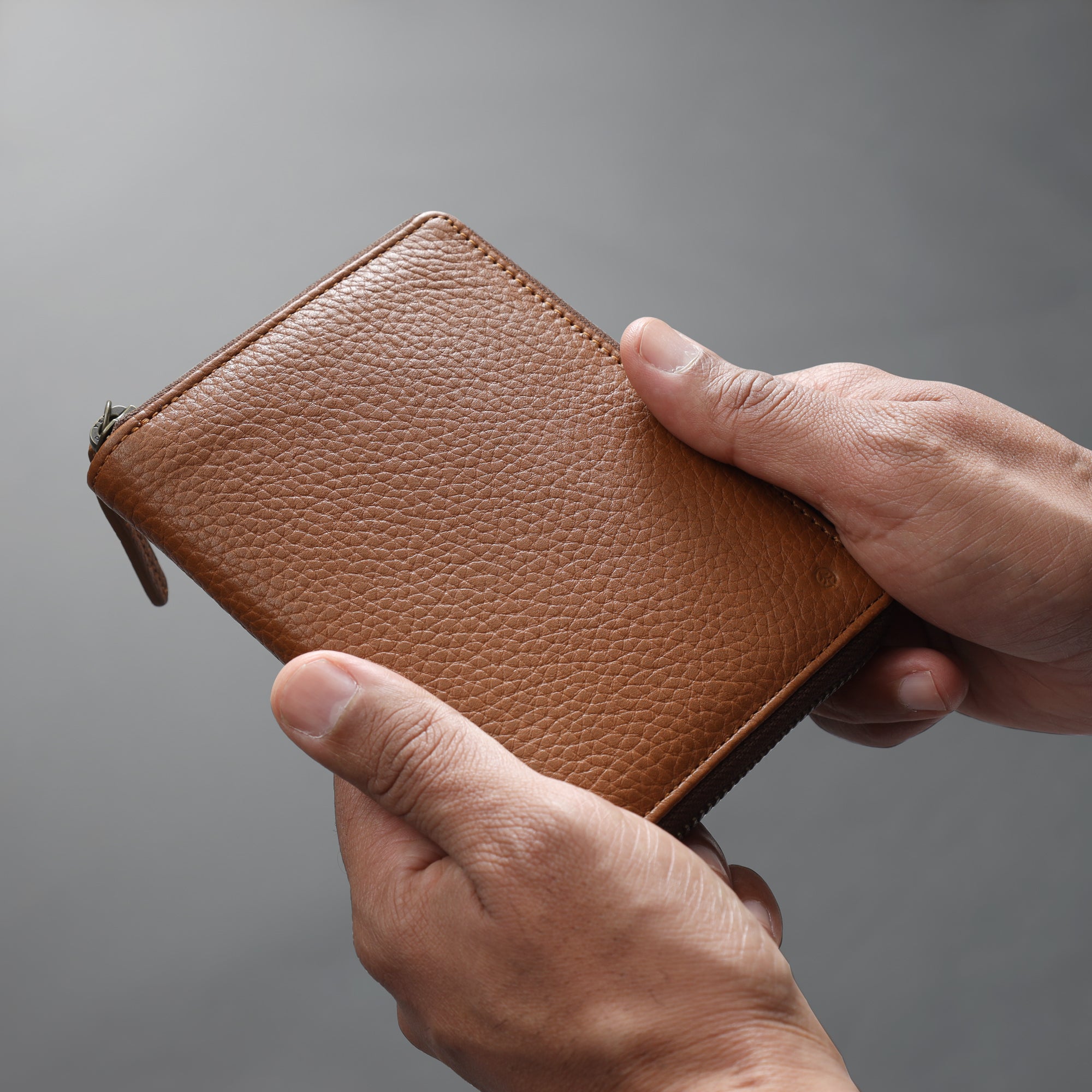 A stylish and functional passport wallet made from premium full grain leather, featuring multiple pockets and a secure zipper closure.