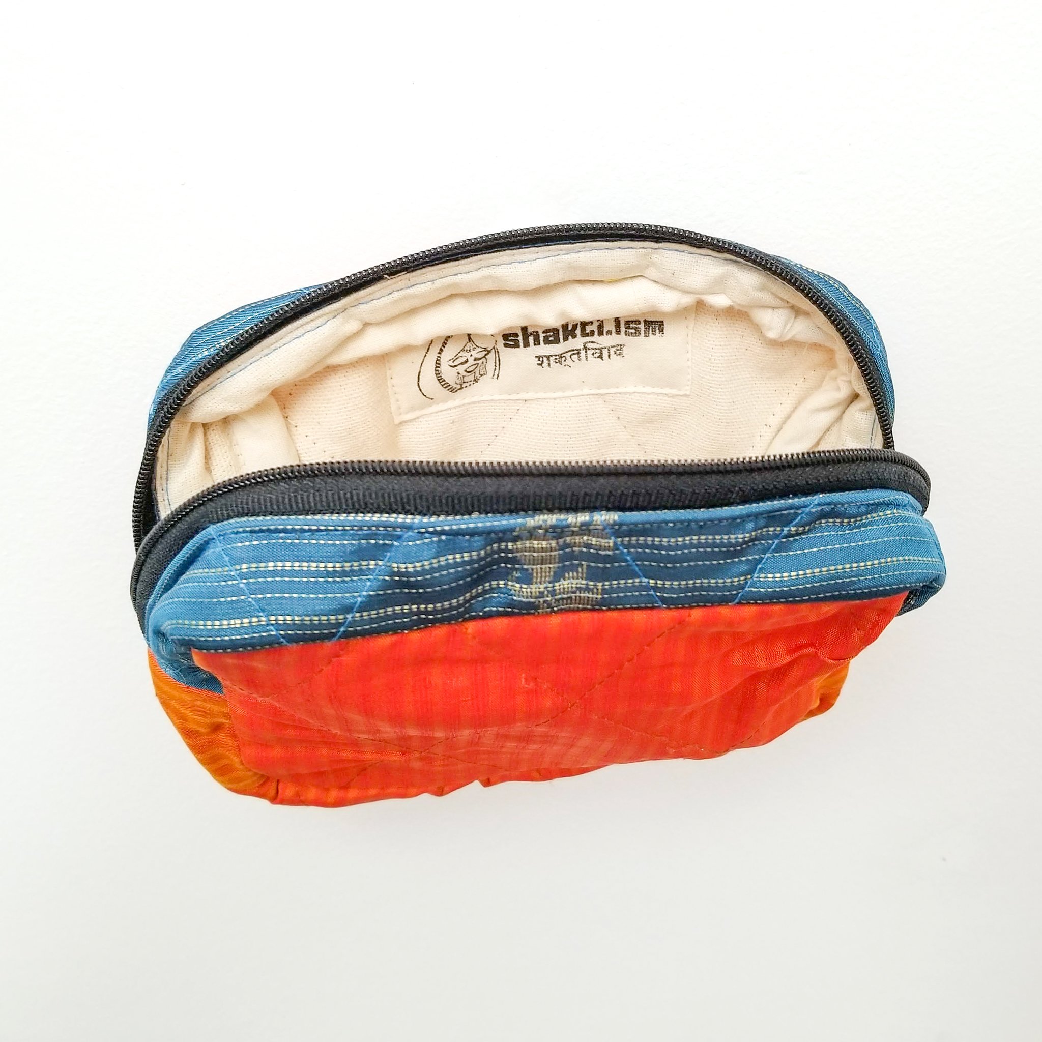 Colorful patchwork sari box pouch handcrafted by artisans in India, showcasing unique patterns and vibrant colors.