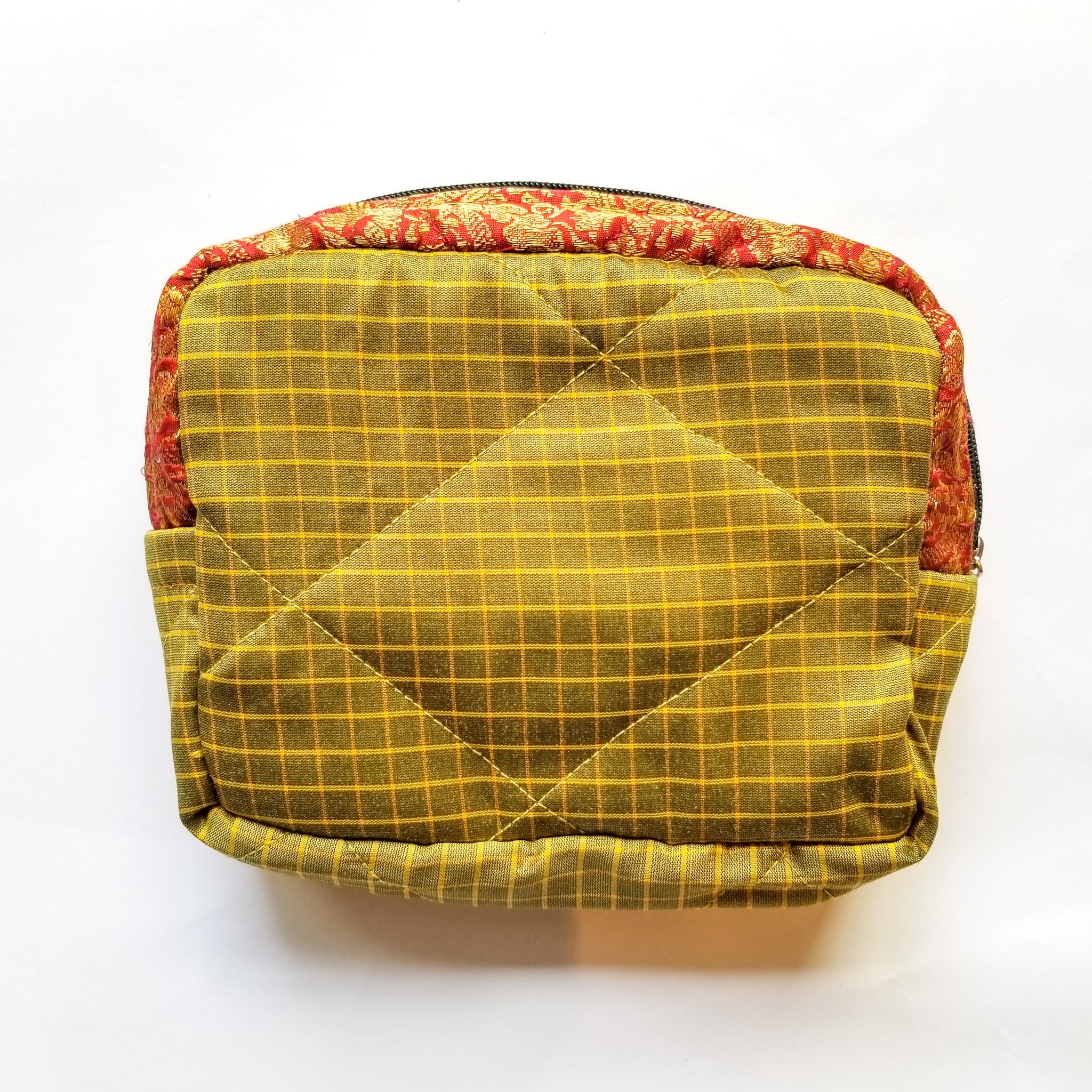 Colorful patchwork sari box pouch handcrafted by artisans in India, showcasing unique patterns and vibrant colors.