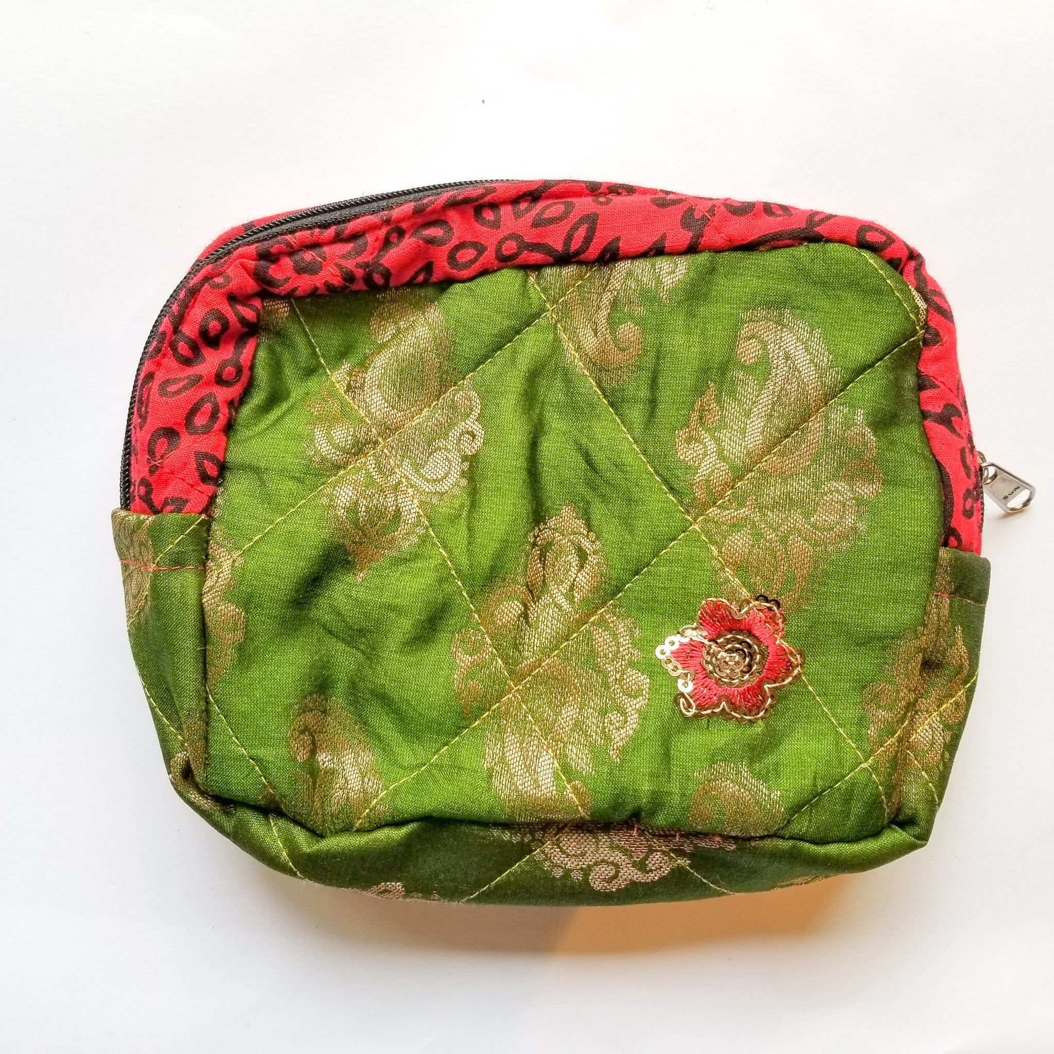 Colorful patchwork sari box pouch handcrafted by artisans in India, showcasing unique patterns and vibrant colors.