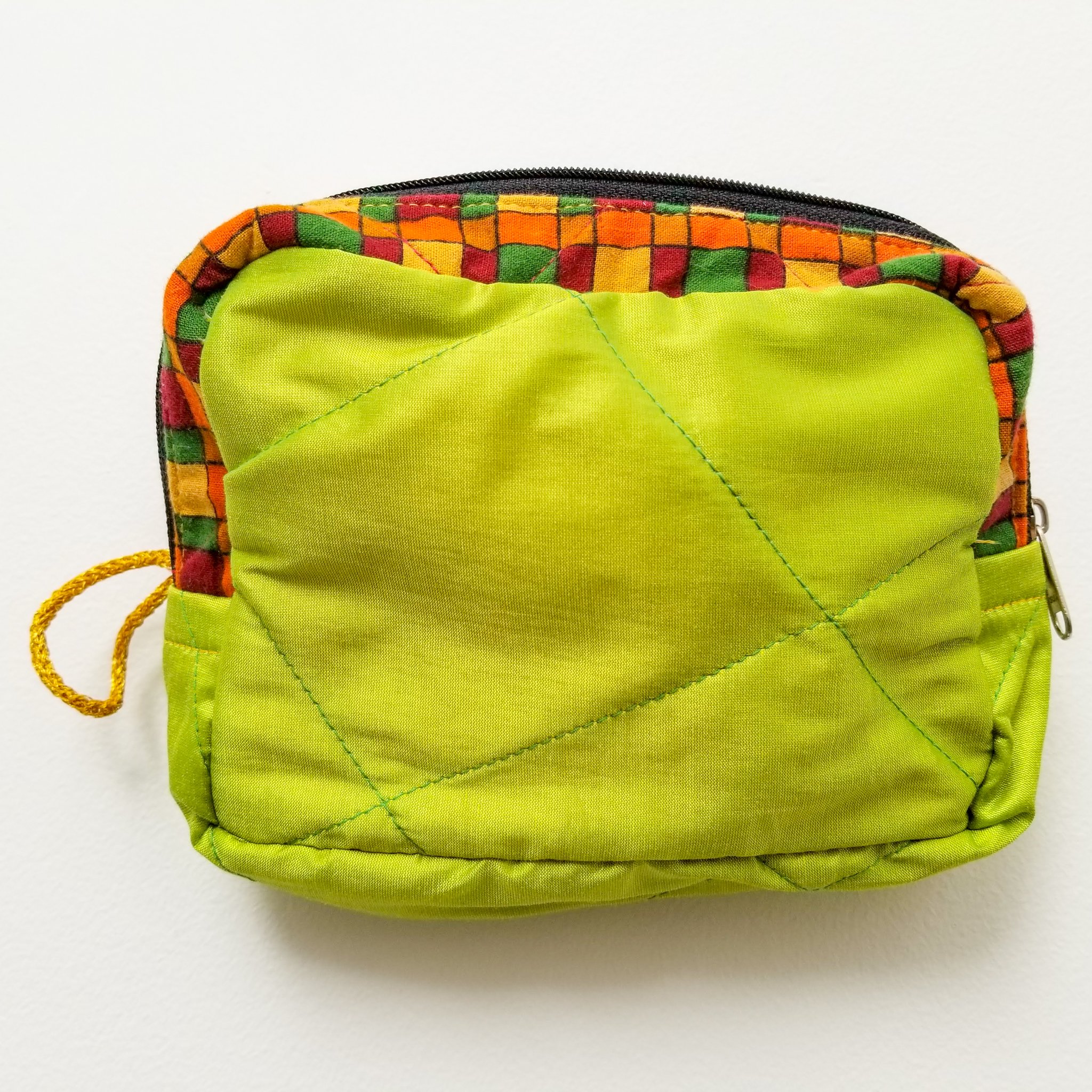 Colorful patchwork sari box pouch handcrafted by artisans in India, showcasing unique patterns and vibrant colors.