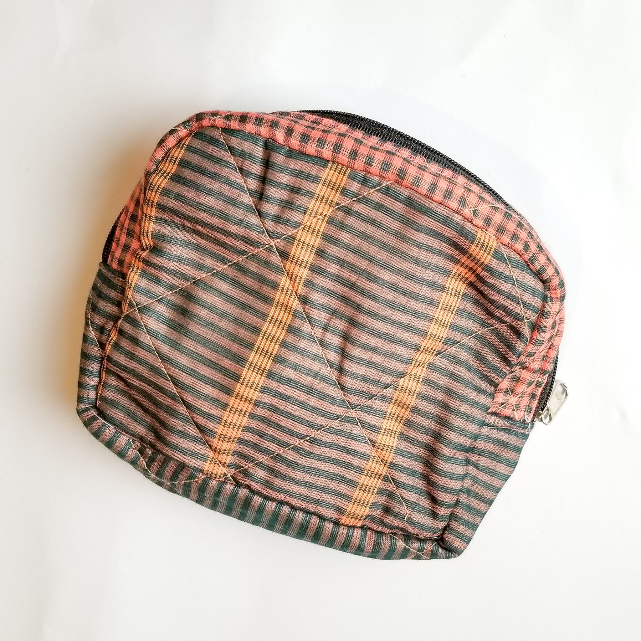 Colorful patchwork sari box pouch handcrafted by artisans in India, showcasing unique patterns and vibrant colors.