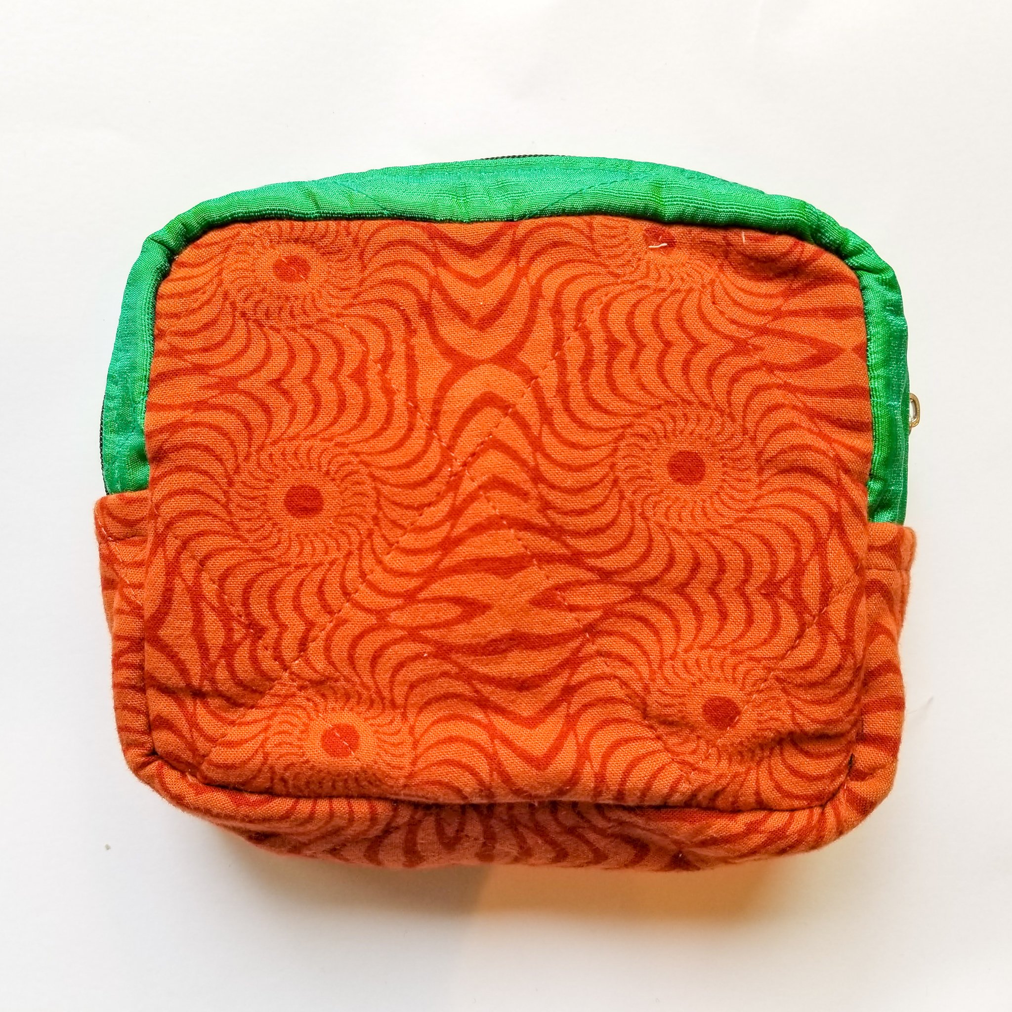 Colorful patchwork sari box pouch handcrafted by artisans in India, showcasing unique patterns and vibrant colors.