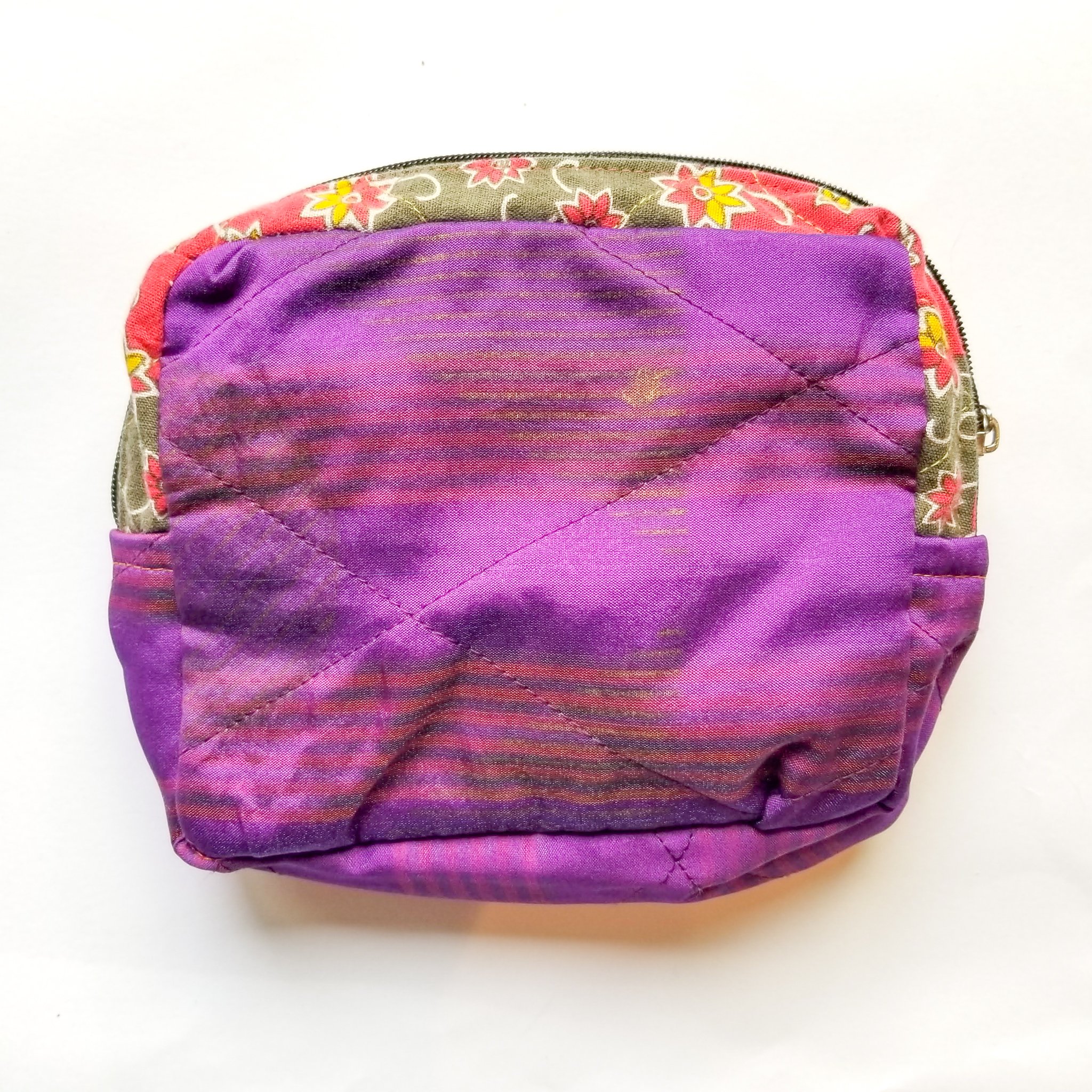 Colorful patchwork sari box pouch handcrafted by artisans in India, showcasing unique patterns and vibrant colors.