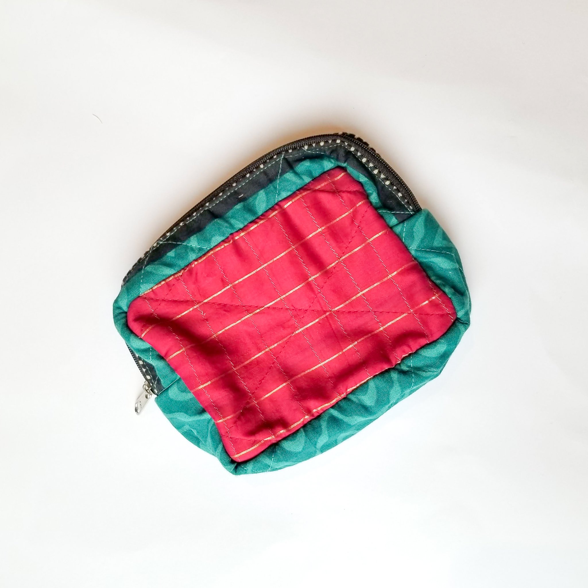 Colorful patchwork sari box pouch handcrafted by artisans in India, showcasing unique patterns and vibrant colors.