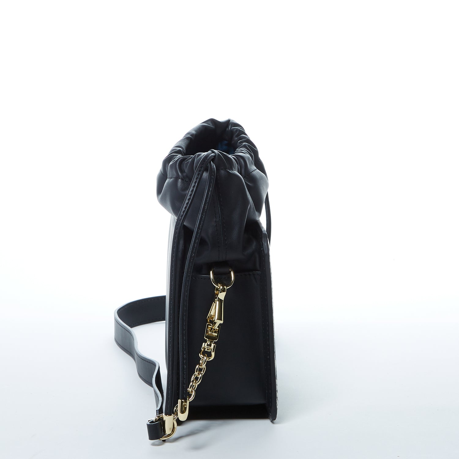 Patricia Black Leather Bucket Bag featuring a unique snakeskin design with gold hardware and teal interior.