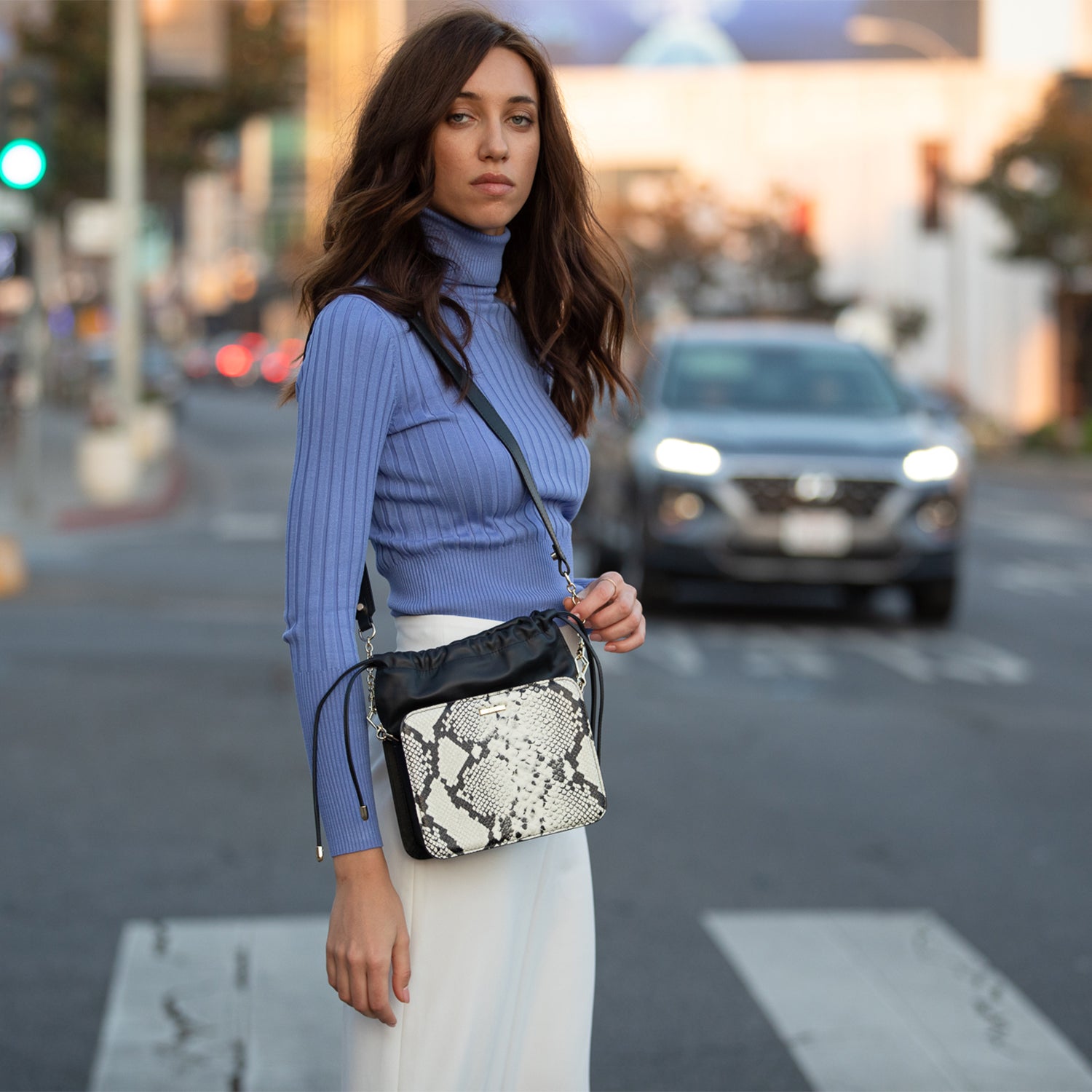 Patricia Black Leather Bucket Bag featuring a unique snakeskin design with gold hardware and teal interior.