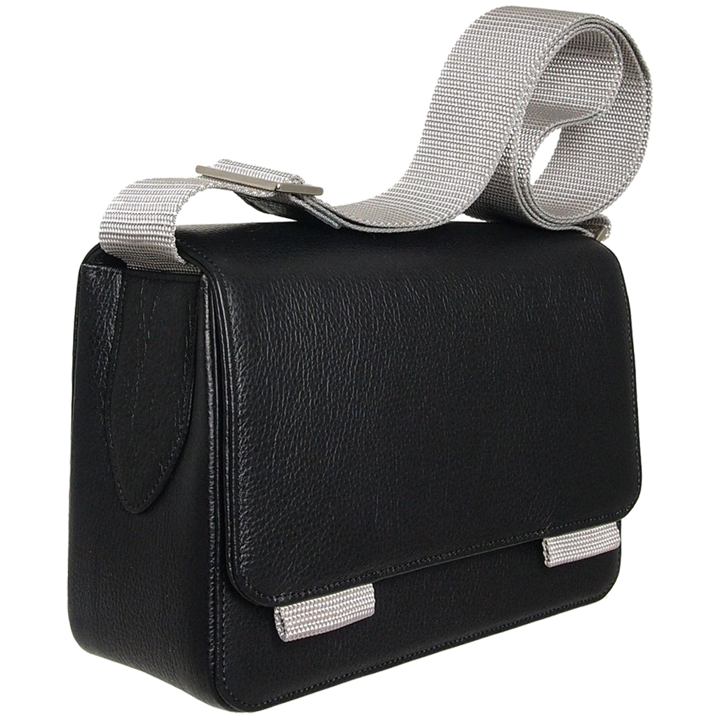 A stylish black pebbled leather crossbody bag with a contrasting vinyl strap, featuring a magnetic flap closure and handmade craftsmanship from Milan, Italy.