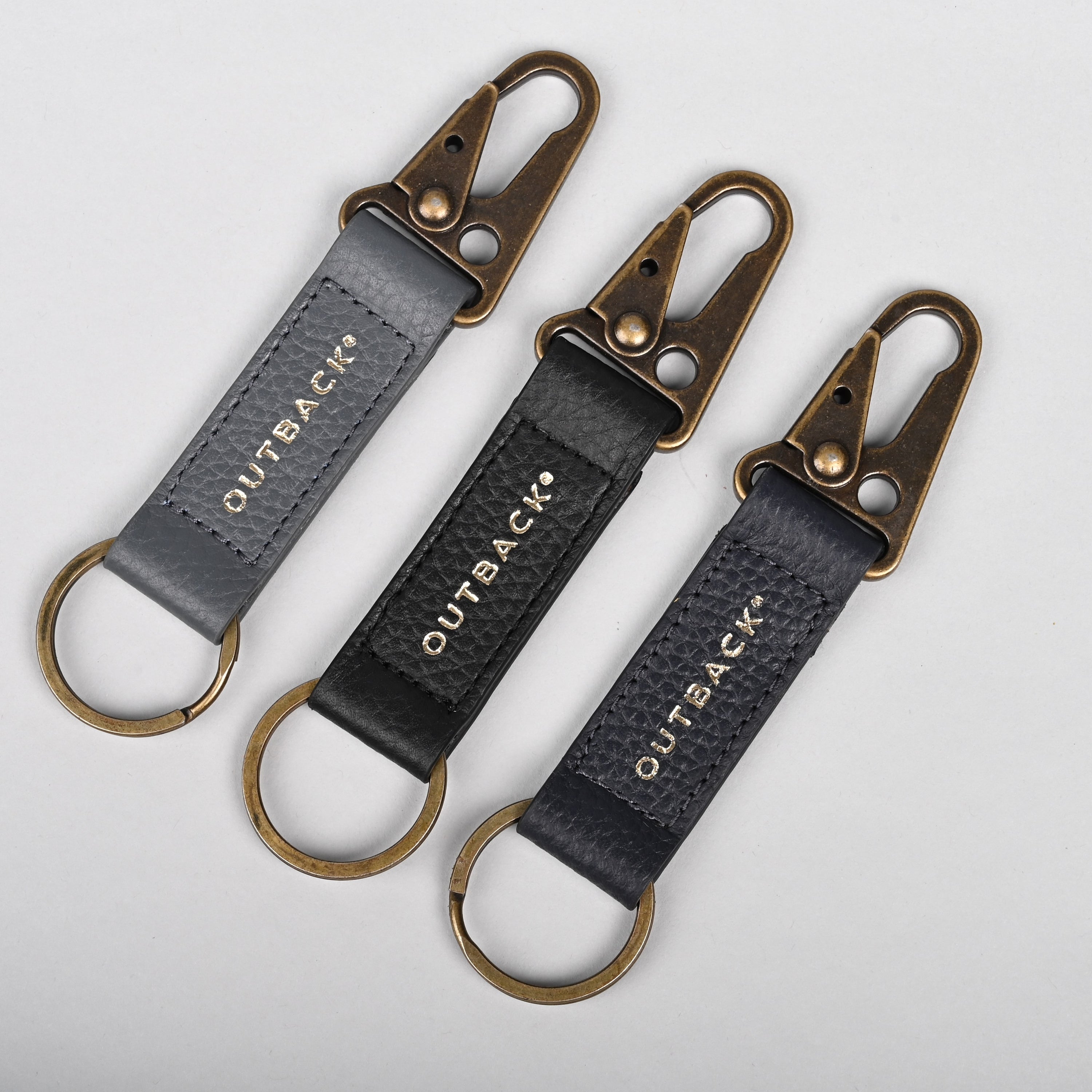 Performance Key Holder made from premium leather with antique brass hardware, showcasing its elegant design and snap hook mechanism.