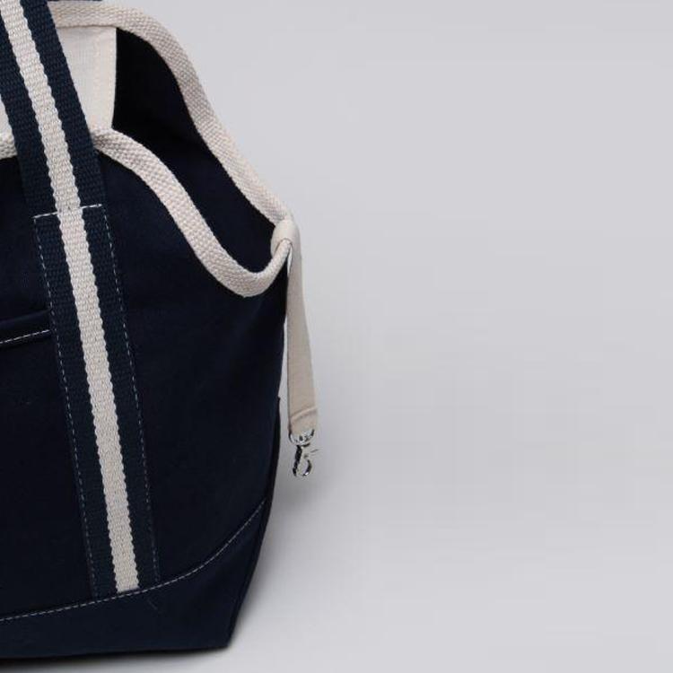 A spacious and stylish Pet Carrier Tote Bag made of heavyweight cotton canvas, featuring a zippered top, peek-a-boo opening, and an outside pocket.