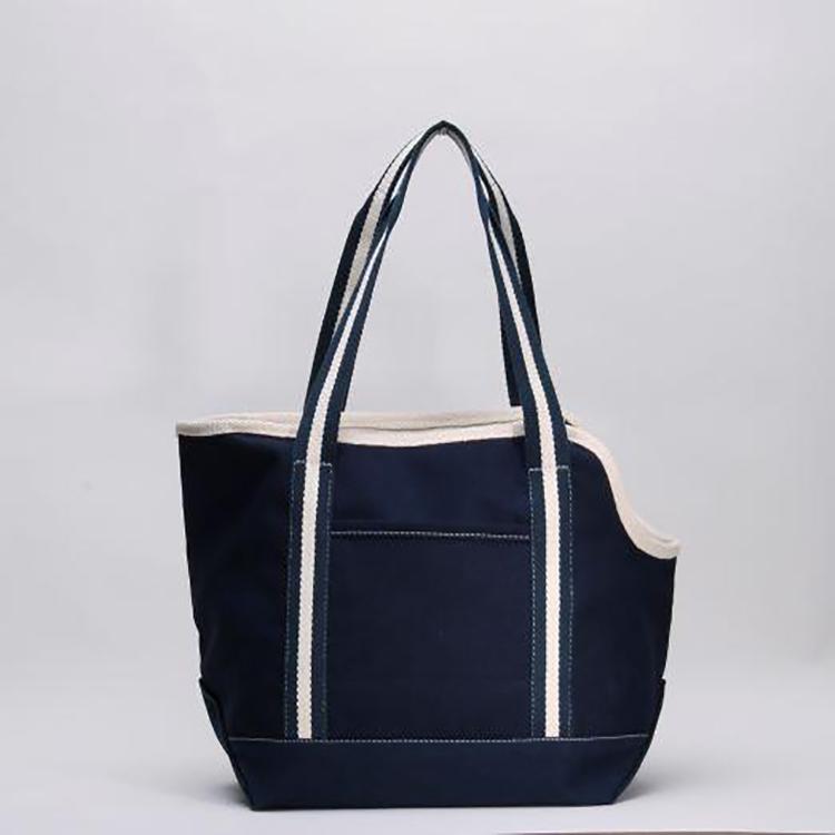 A spacious and stylish Pet Carrier Tote Bag made of heavyweight cotton canvas, featuring a zippered top, peek-a-boo opening, and an outside pocket.