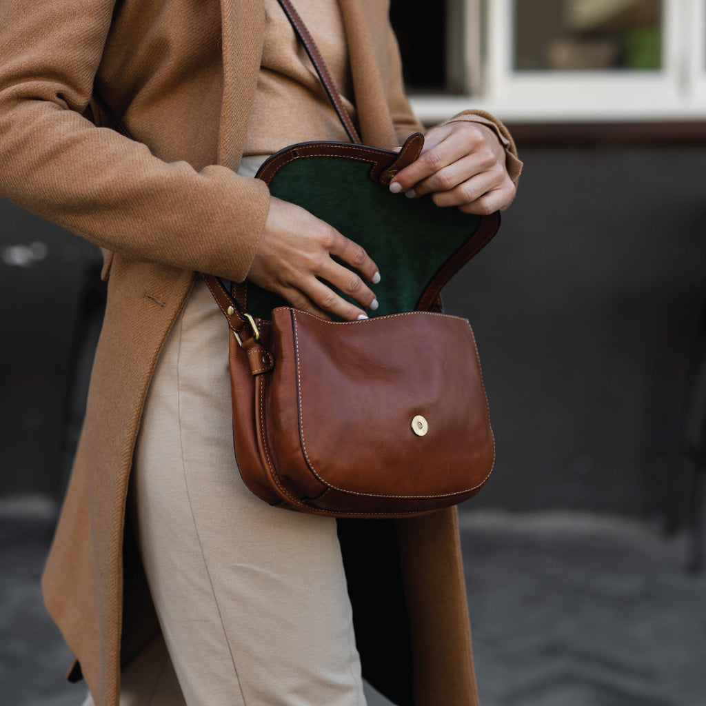 Petite Ladies Crossover Handbag in Colt color with elegant stitching and rounded design.