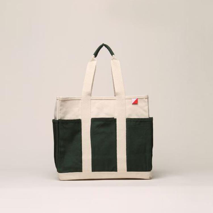 A medium-sized Pocket Tote made from heavy-duty recycled cotton canvas, featuring eight external gusseted pockets for organization.