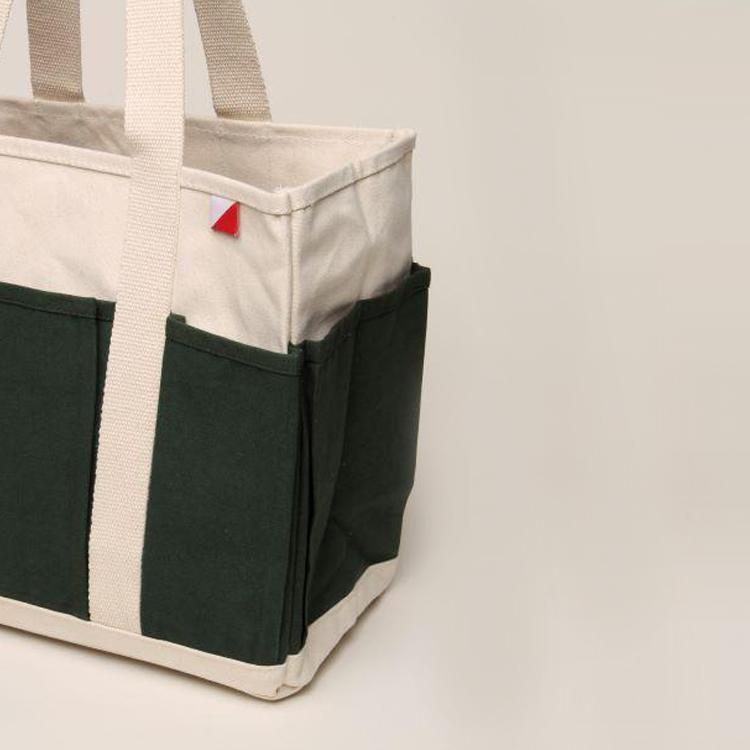 A medium-sized Pocket Tote made from heavy-duty recycled cotton canvas, featuring eight external gusseted pockets for organization.