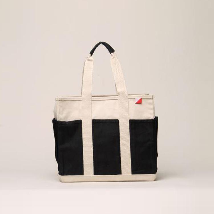 A medium-sized Pocket Tote made from heavy-duty recycled cotton canvas, featuring eight external gusseted pockets for organization.