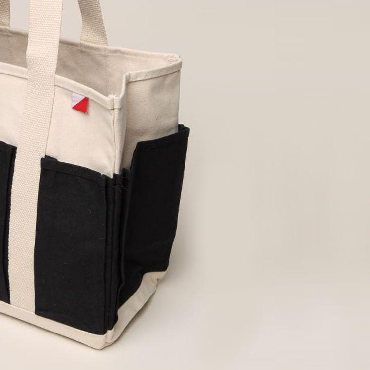 A medium-sized Pocket Tote made from heavy-duty recycled cotton canvas, featuring eight external gusseted pockets for organization.