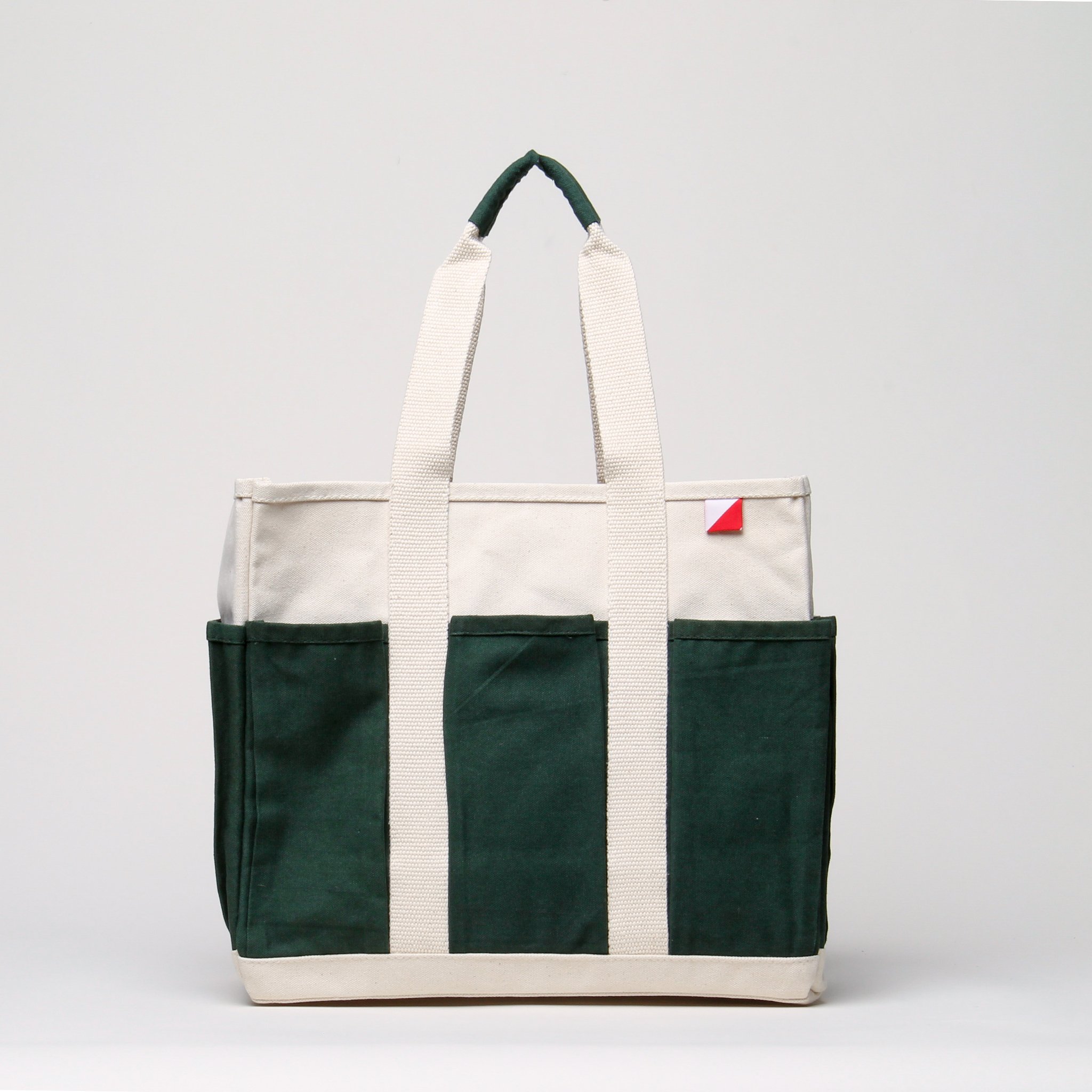 A medium-sized Pocket Tote made from heavy-duty recycled cotton canvas, featuring eight external gusseted pockets for organization.