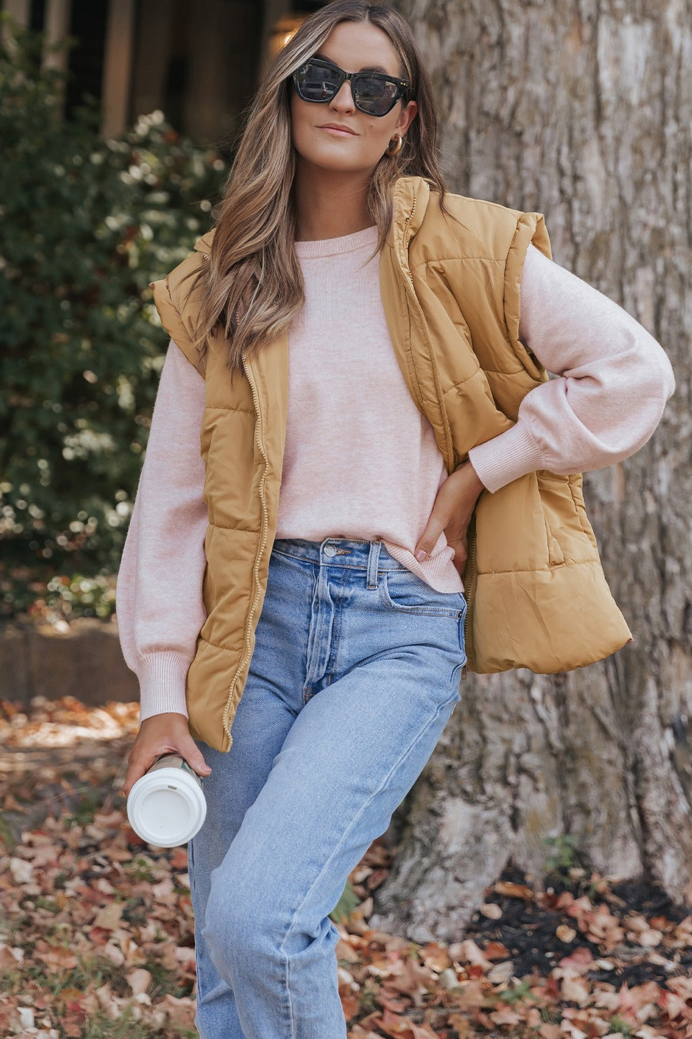 A stylish Pocketed Zip Up Vest Coat in a neutral color, featuring a zip closure and pockets, perfect for layering in various outfits.