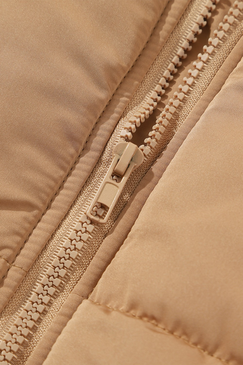 A stylish Pocketed Zip Up Vest Coat in a neutral color, featuring a zip closure and pockets, perfect for layering in various outfits.