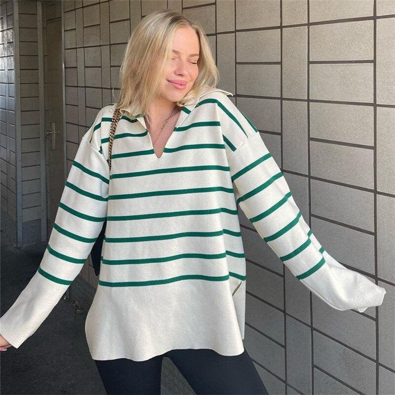 A stylish women's knit striped sweater featuring a turtleneck collar and full-length sleeves, perfect for autumn and winter wear.