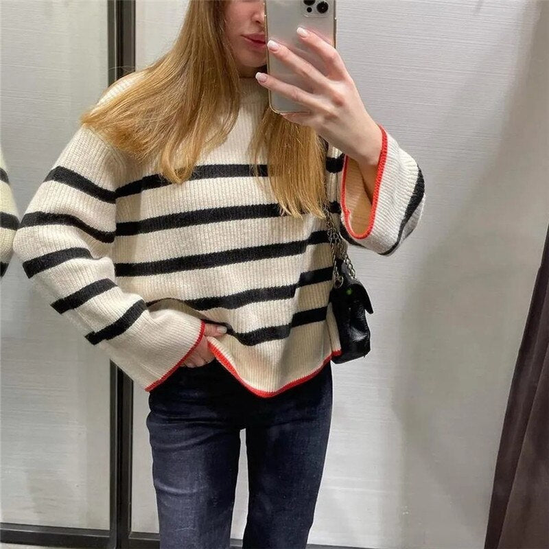 A stylish women's knit striped sweater featuring a turtleneck collar and full-length sleeves, perfect for autumn and winter wear.